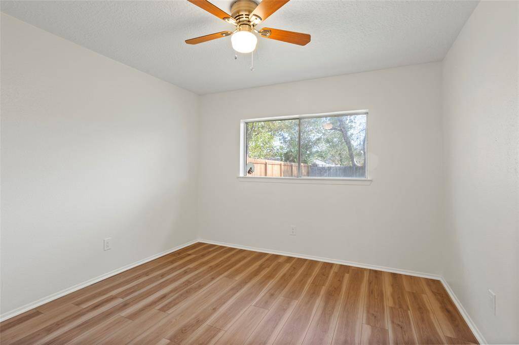 On the other side of the house, we have the guest bedrooms. This one faces the back of the home.