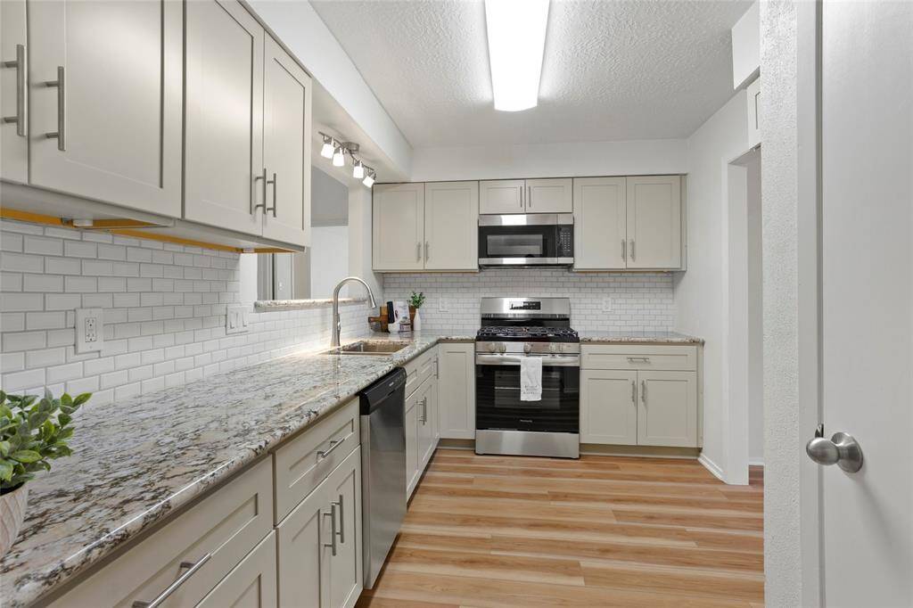 The gorgeous kitchen has been completely renovated! (Dec 2024) Pantry is on the right. Doorway on the right goes back to the flex room.
