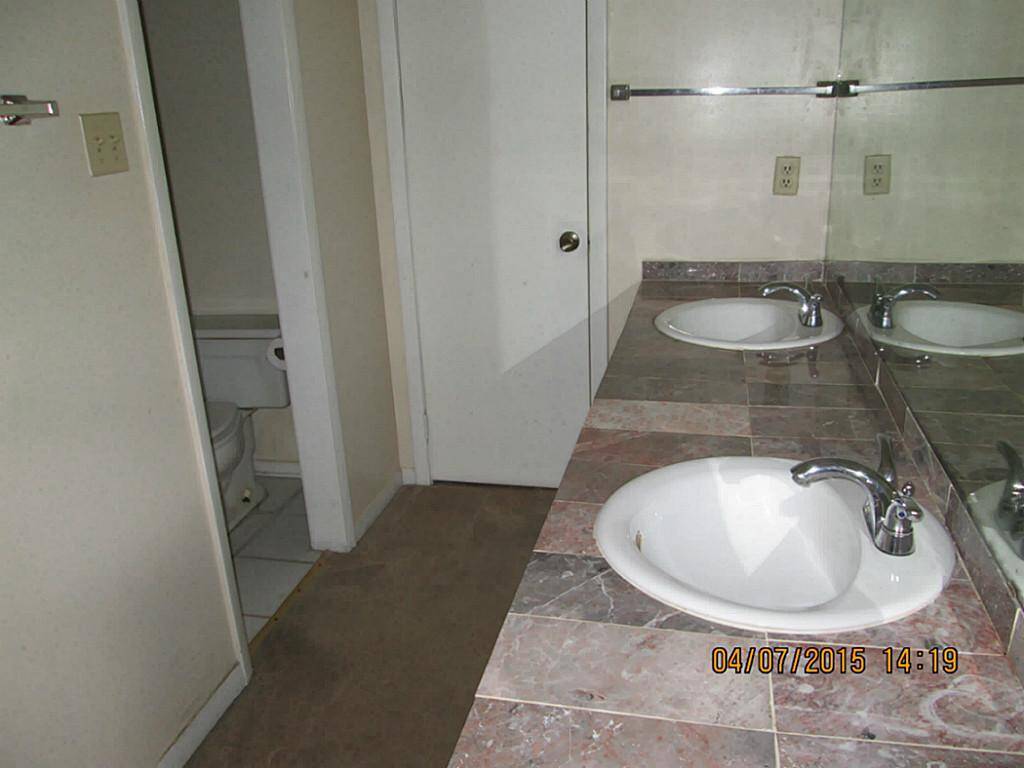 Recent marble countertops and sinks  and faucets in the master bathroom.