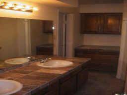 Recent sink, faucets, and marble countertops in master bathroom with 2 walk in closets