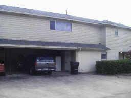 2 car covered carport separates front from back unit.