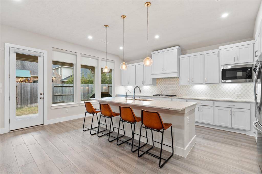 Pendant lighting above the island adds a sophisticated touch.