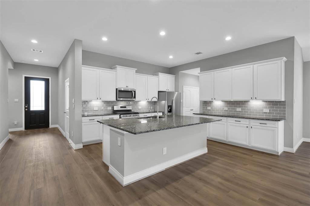 Inviting Kitchen with Butler Area, Under Counter Lighting and Generous cabintry and countertop space.
