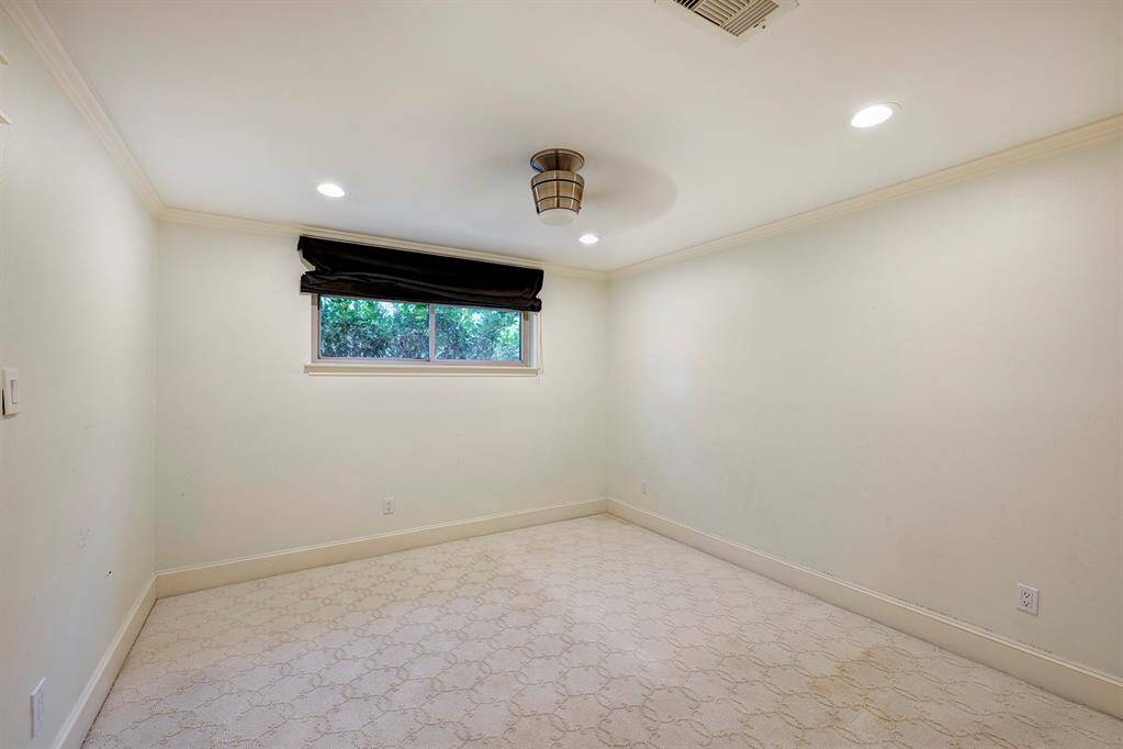 Primary bath has dual sinks in this custom furniture like cabinets and beautiful mirror. Frameless shower door.