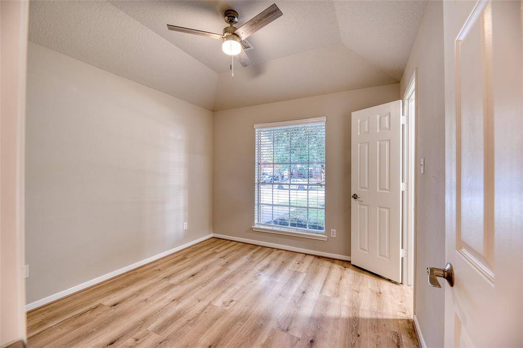 Bright and airy secondary bedroom with a ceiling fan and ample natural light.