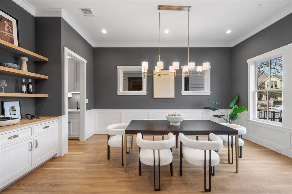 The dining room is large and has a beautiful chandelier.