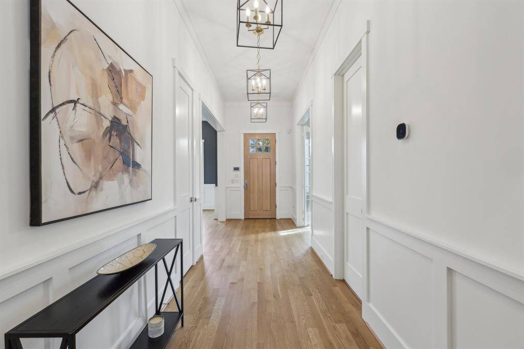 The hall way is wide and has a coat closet