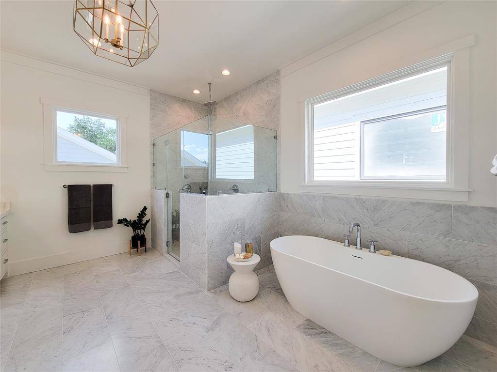 Relax in the inviting primary bath. Treat yourself to a bubble bath in this beautiful soaking tub. The walk in shower has a glass door and tile for privacy.