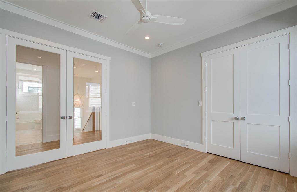 Bedroom/gameroom on the second floor offers a nice size closet, 10 ft cellings, French doors that open to wide hall way.