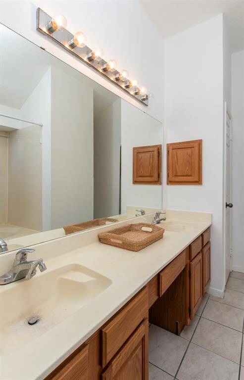 The primary ensuite offers a large vanity with dual sinks and knee area and linen closet.