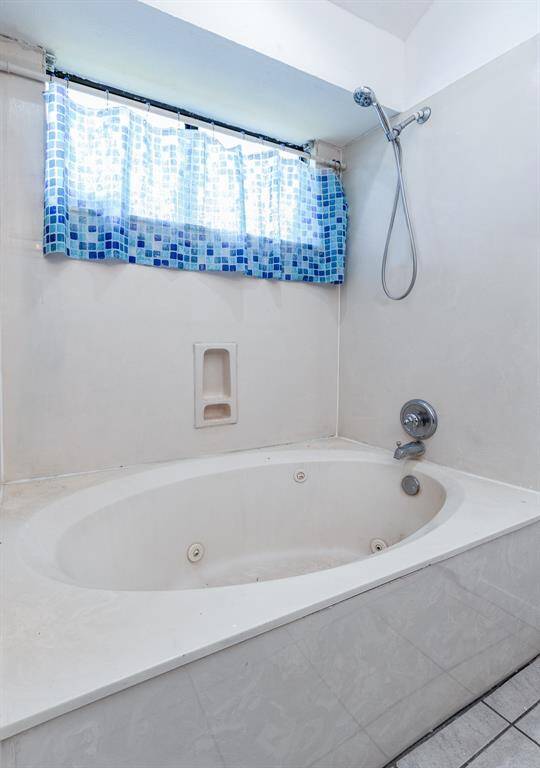 Spacious 2nd bedroom with triple wide closet and views of the backyard.