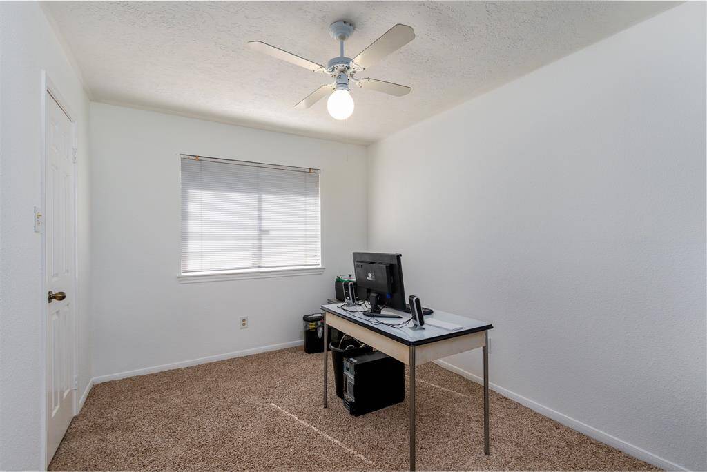 3rd bedroom being used as an office offers ceiling fan and walk in closet.