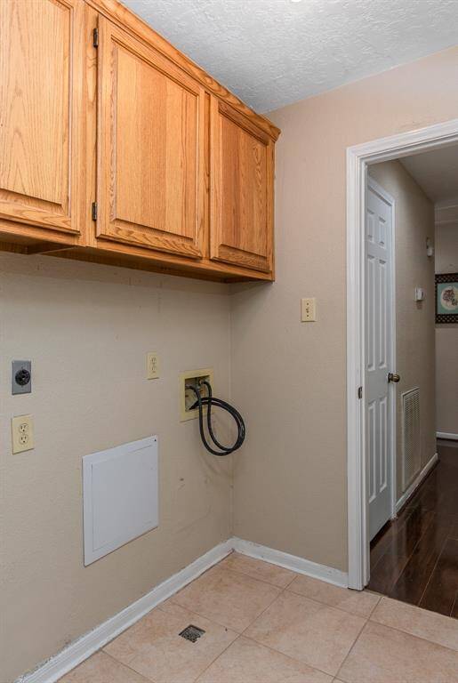 Convenient indoor utility room with storage cabinets, plus two hallway closets, perfectly situated near bedrooms and garage.