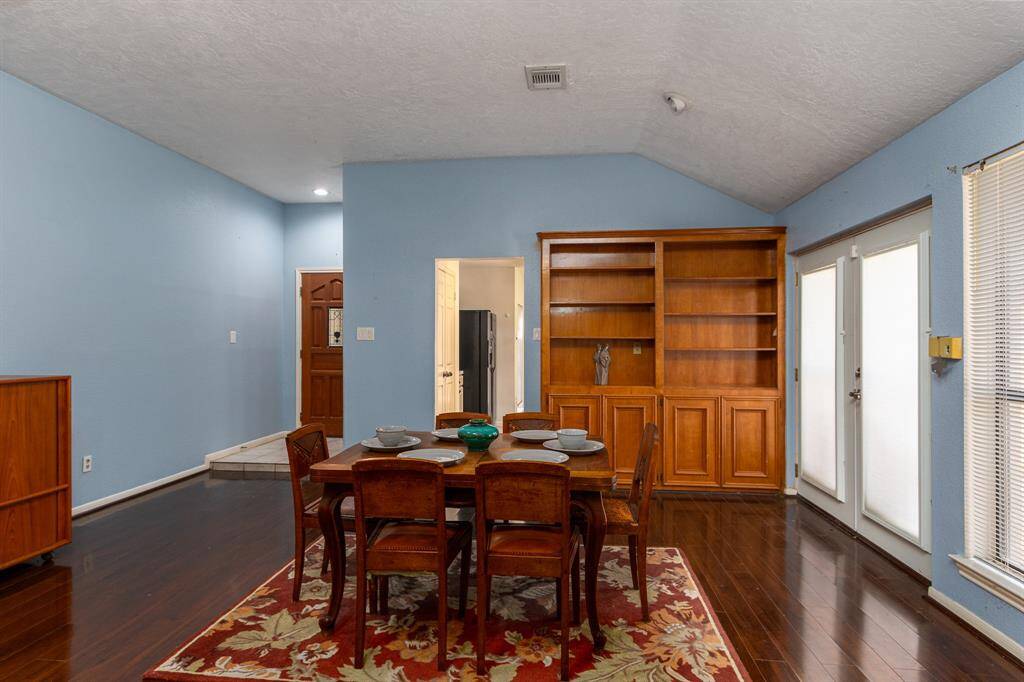 Just off the entry and kitchen, this expansive family room continues to impress with its thoughtful design. This room features stunning built in cabinets that provide ample storage for extra dining items, serving pieces or lines while also showcasing family heirlooms and treasured photos.