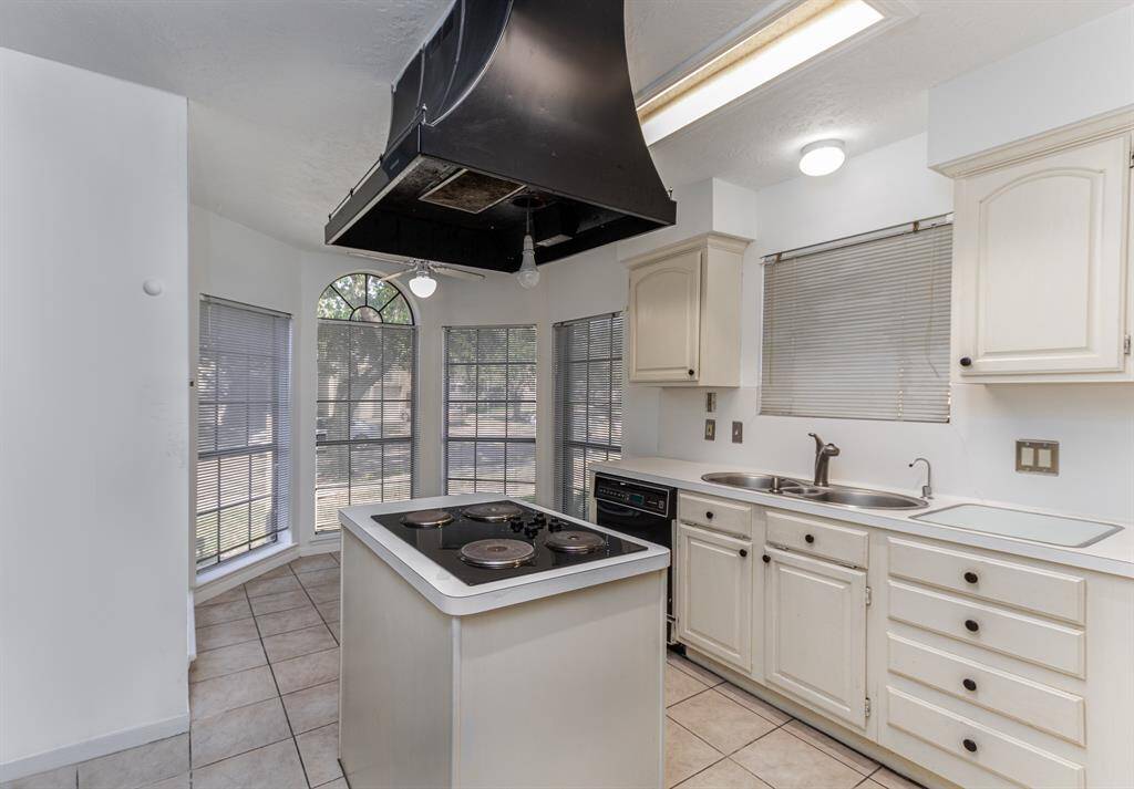 Spacious island kitchen with cooktop offers an abundance of cabinet and counter space and opens to the bright and cheerful breakfast/dining area with bay window.