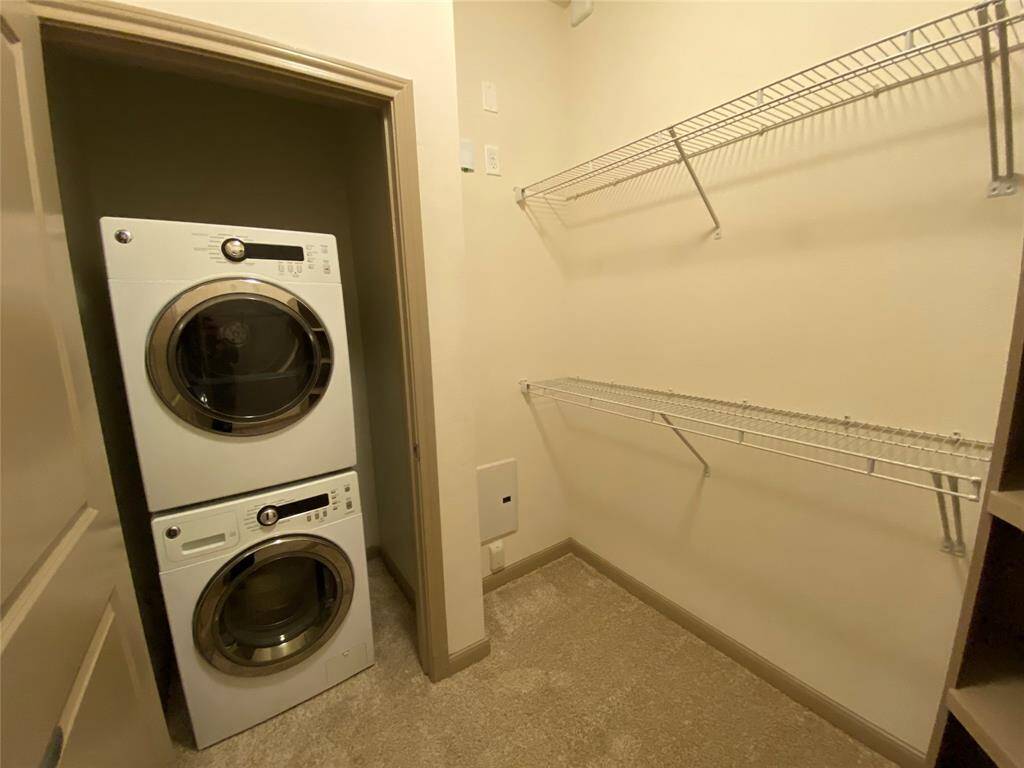 Stacked washer and dryer with extra wire shelving