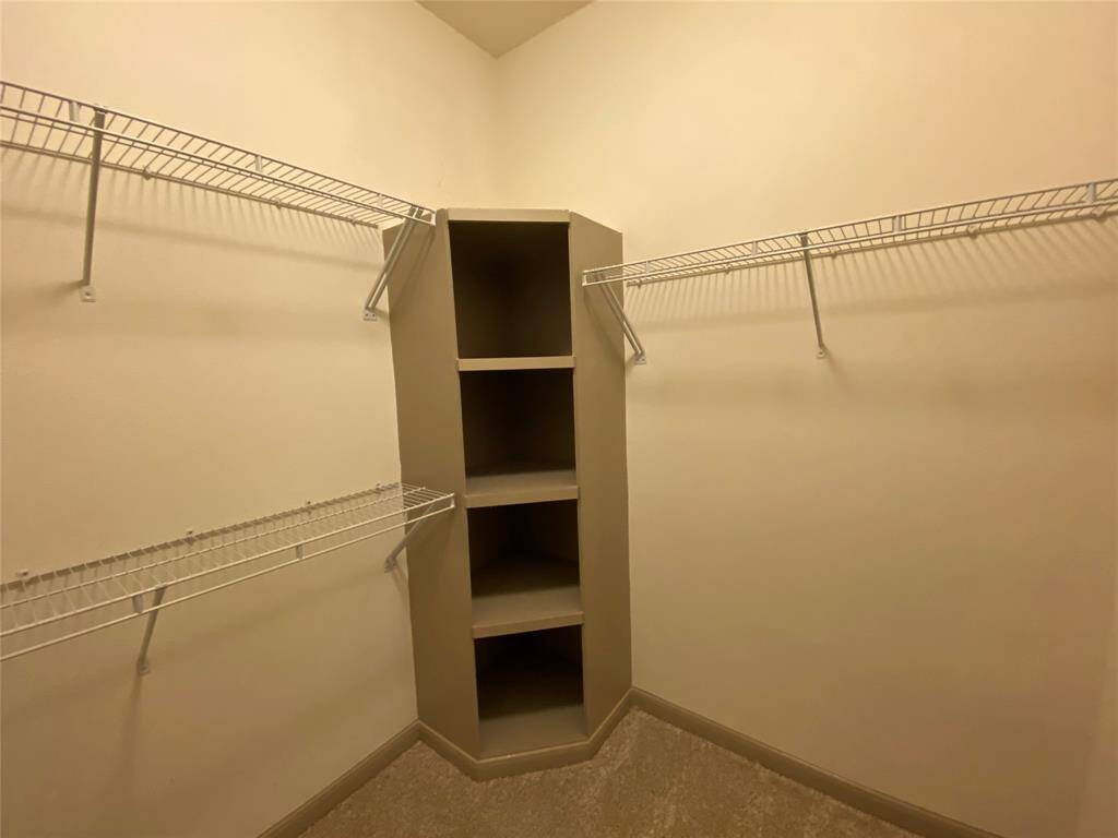 Spacious walk in closet with a built in and wire racks