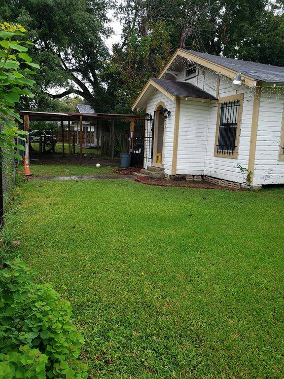 Front of main House. Carport and fenced yard.