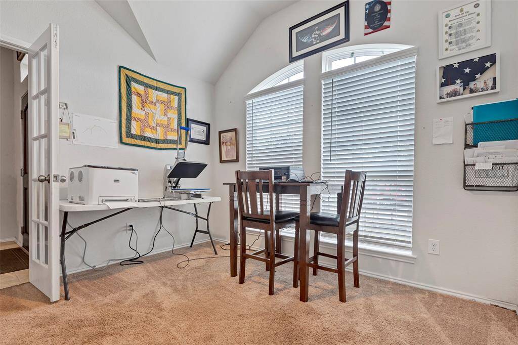 Perfect for work or study, this home office features large twin windows that fill the room with natural light.