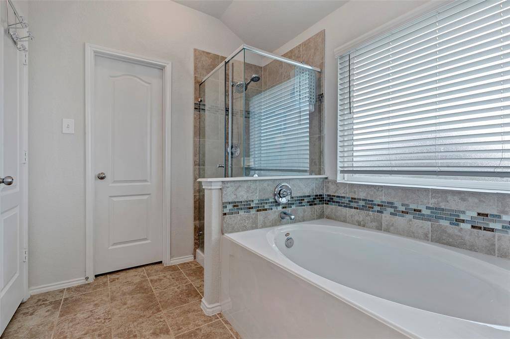 Unwind in the primary bathroom, complete with a separate shower and a luxurious soaking tub.