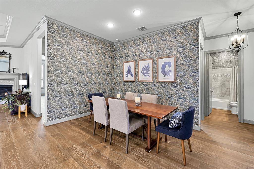 The beautifully appointed dining area features timeless 1800s collection William Morris wallpaper.