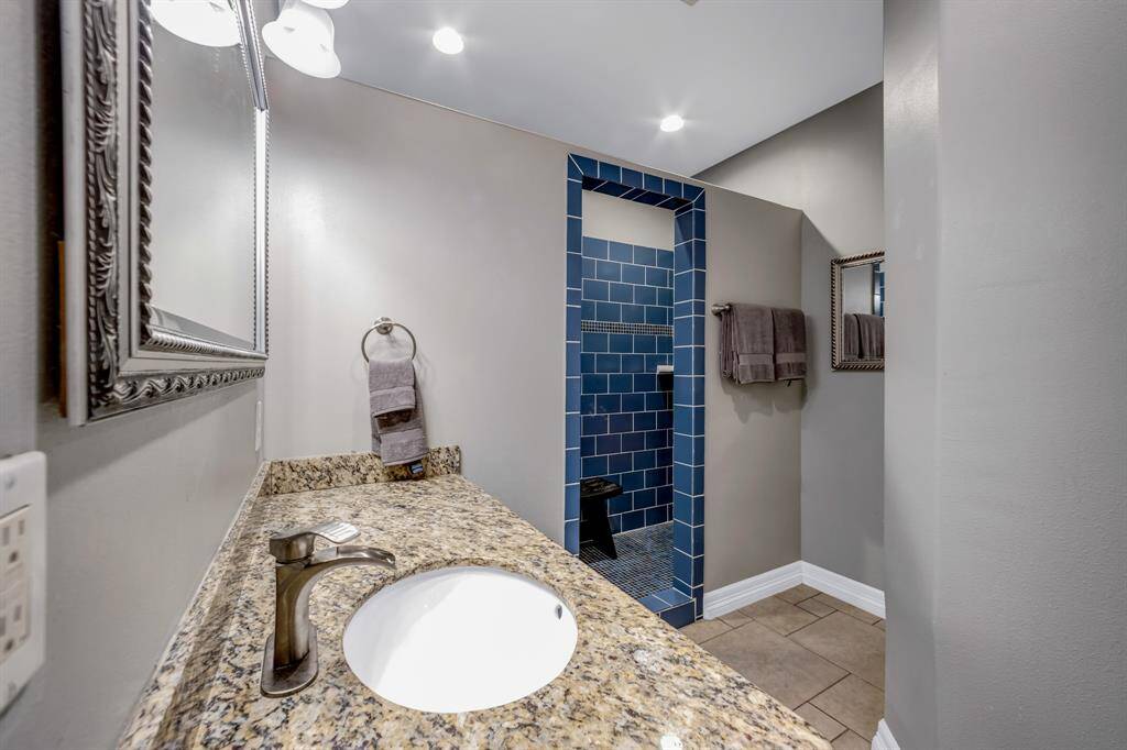 Other end of double shower, framed mirror, canister lights and high-end fixtures