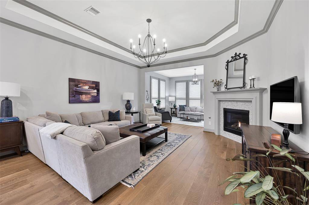 Tray ceilings and a feature chandelier create a beautiful balance and finish to this space.