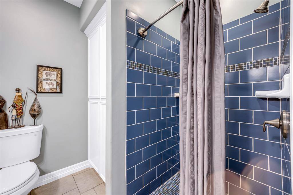 Custom tile shower and large built-in linen cabinet/storage