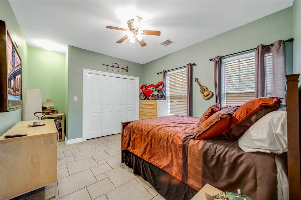 This is the other 11X11 secondary bedroom downstairs. It too has a ceiling fan and tile flooring