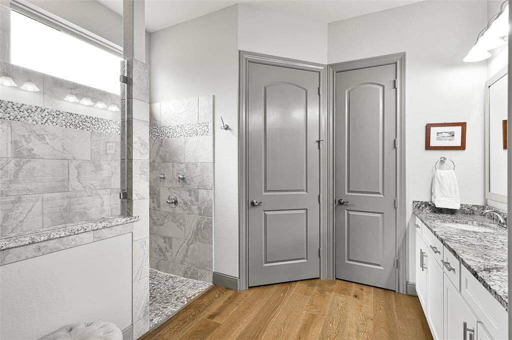 An oversized walk-in shower features your choice of hand held or rainfall shower heads.