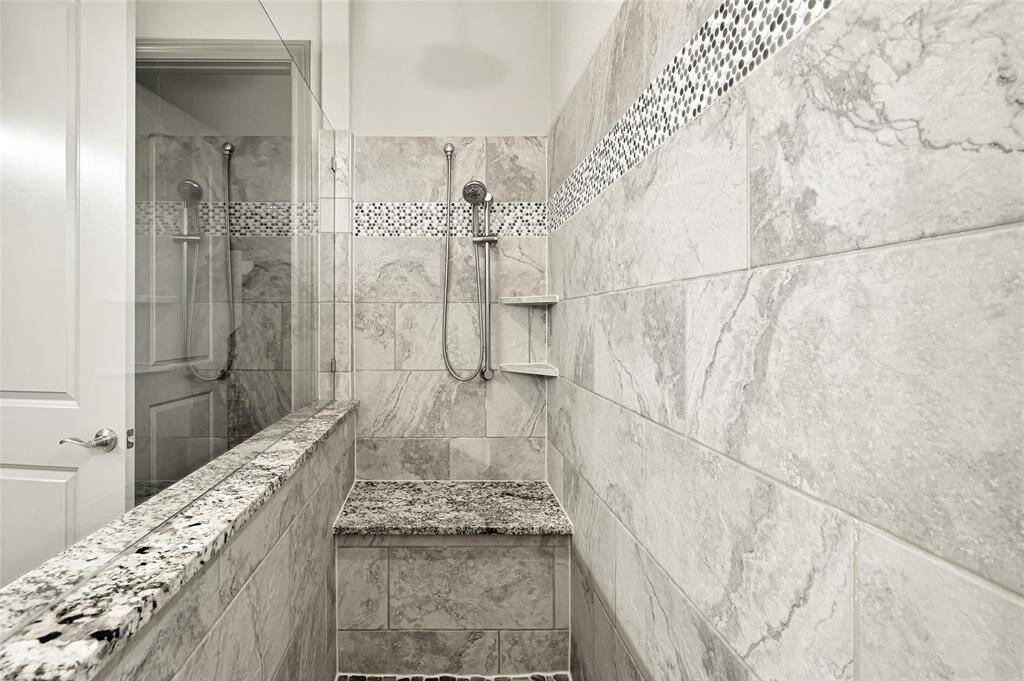 The shower also features built-in seating for comfort and frameless glass.