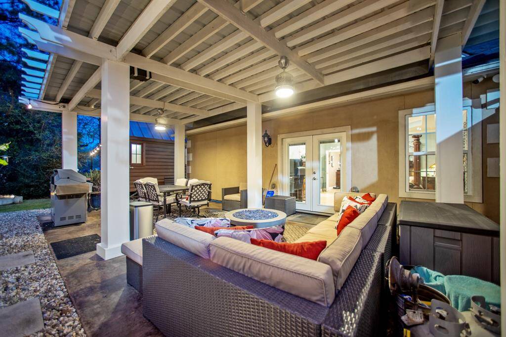 River rock and concrete pads surround the boarder of the covered Pergola Patio