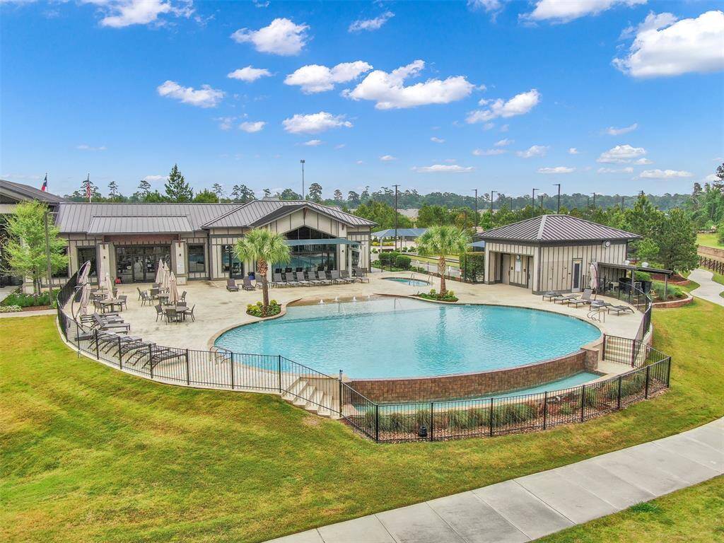 Resort-style pool with beach entry and outdoor hot tub.