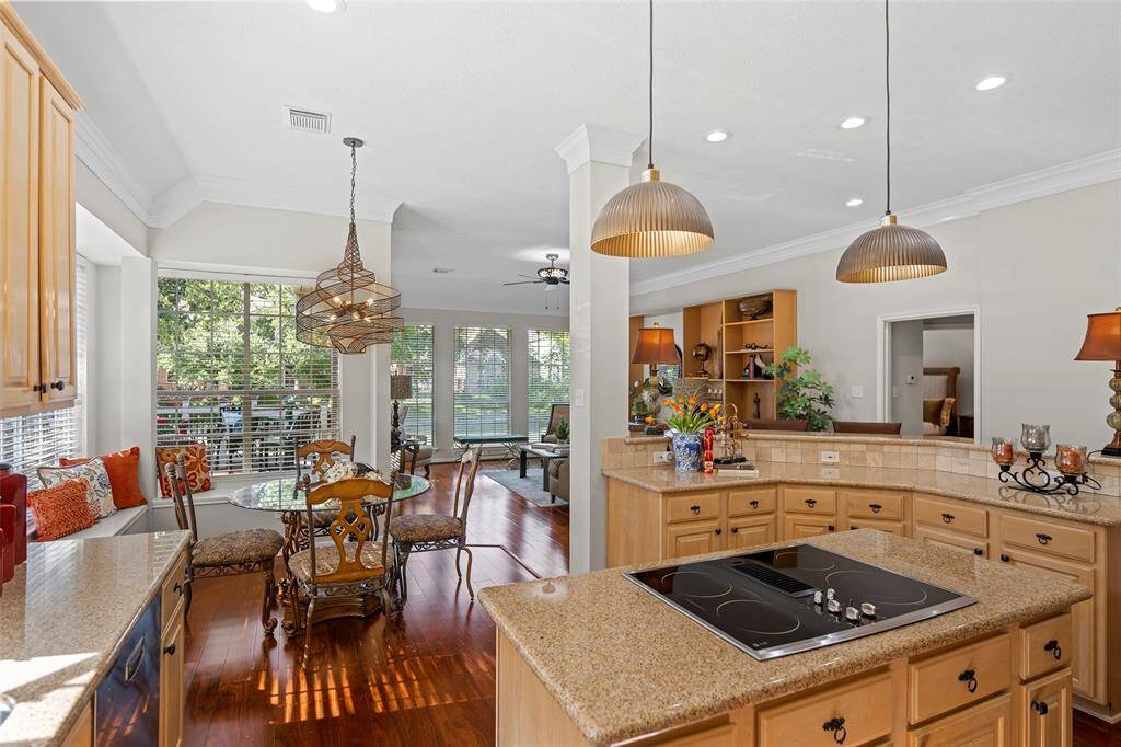 Looking out of the kitchen to the breakfast room and family room that both overlook the garden and lakeside.