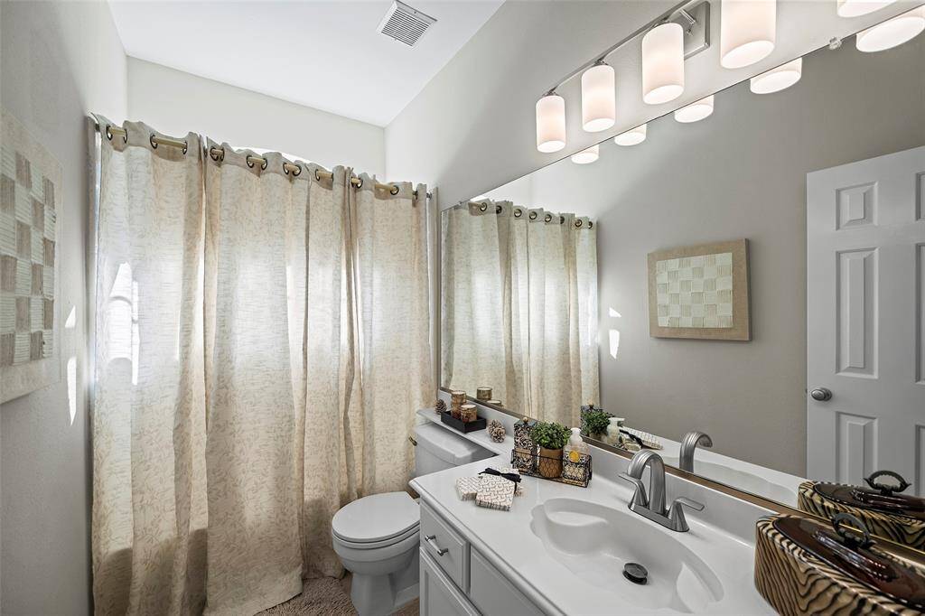 The guest/secondary bathroom with new light and plumbing fixtures.