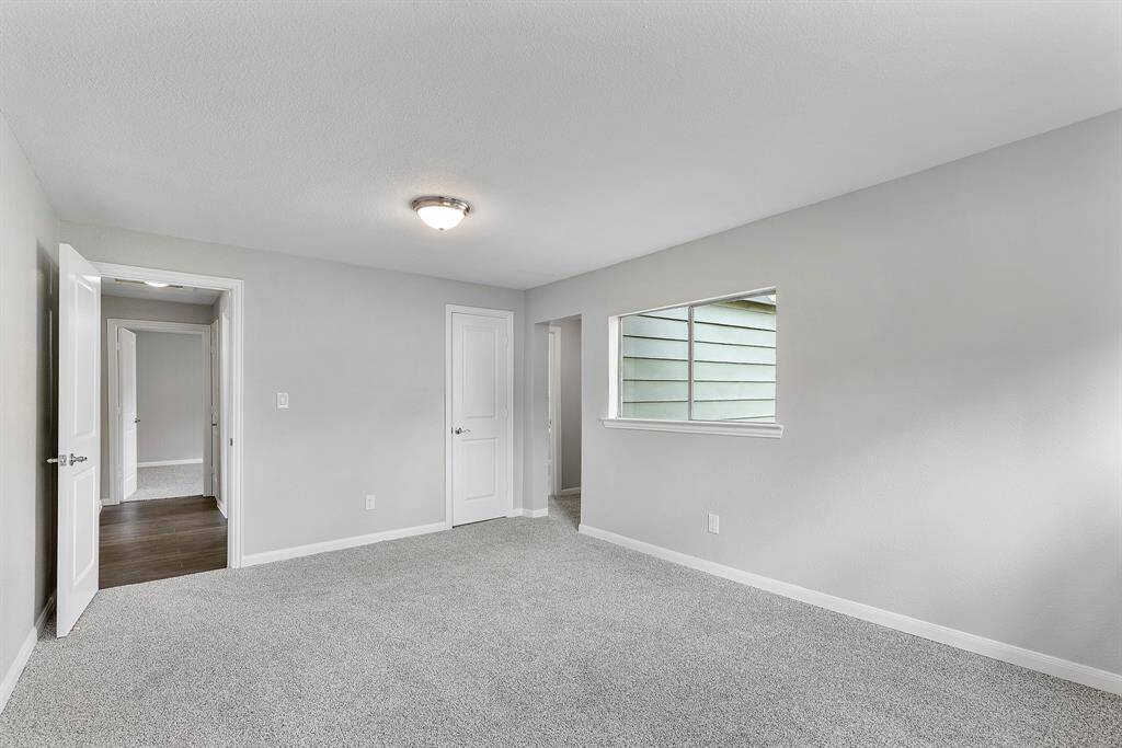 Shows the doorway to the hall on the left and to the Primary closet and bathroom