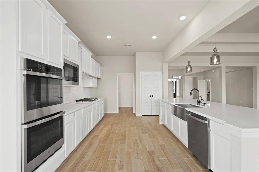 Stylish white cabinets and quartz countertops