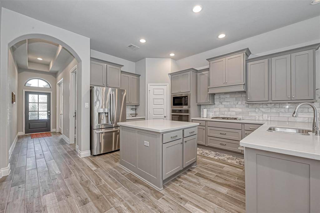 Another view of the kitchen shows the abundance of cabinetry for storage of your finest kitchen utensils! This open-concept home is perfect for entertaining!