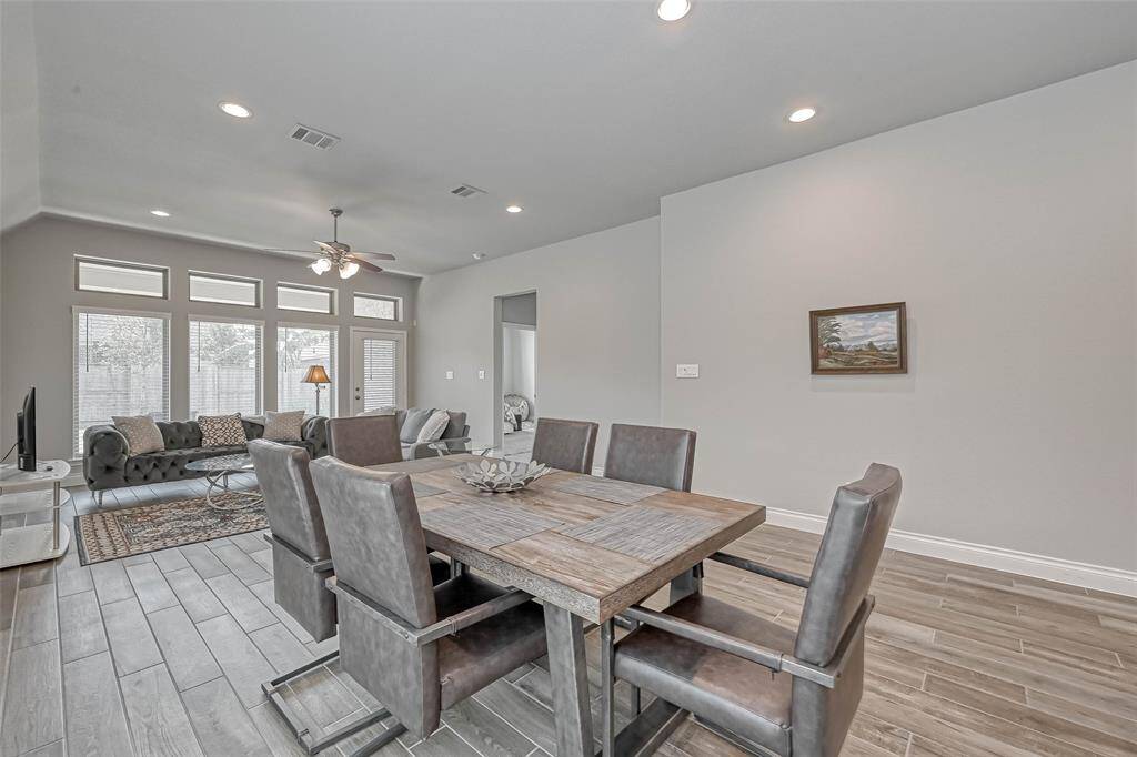 What a stunning open-concept dining area!Features include neutral paint andgorgeous wood look tile floors. This space is open to the living area and kitchen making this the entertainer's dream!