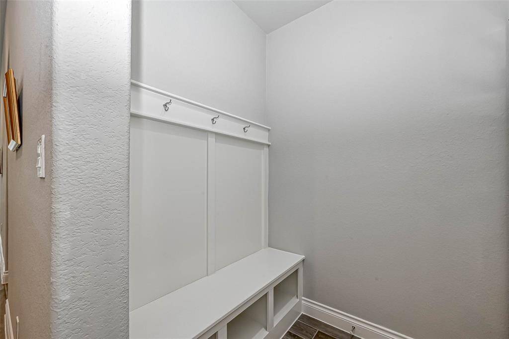 Just off of the garage you will find your mud room that comes complete with a bench and cubbies for shoes, etc. You also have hooks for hanging things!