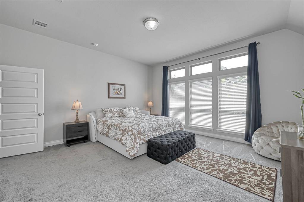 Welcome to your spacious primaryretreat! Features include plushcarpet, decorator paint, and a tall ceiling. You also have floor to ceiling windows that overlook the yard and provide natural light!