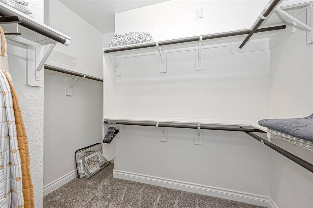 Wow! This dream walk-in closet offers an abundance of space for your large annual wardrobe! Built in shelving surrounds the perimeter!