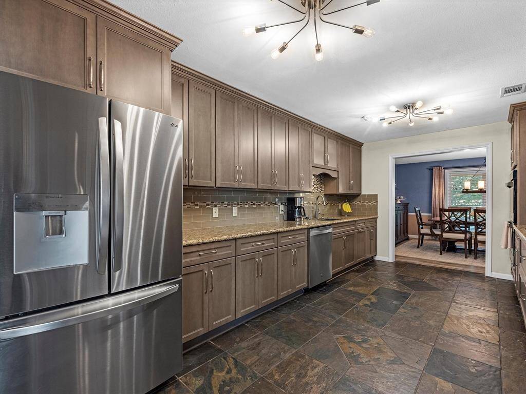 Kitchen with Stainless Steel Refrigerator that conveys