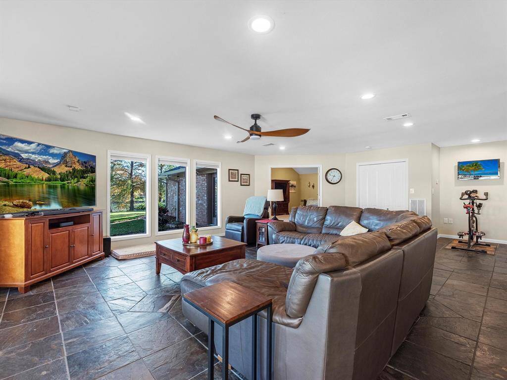 Living Area (1 of 2) that features floor is ceiling windows that span the entire back of the home (from the breakfast area, all the way to the door of the Main Primary Suite