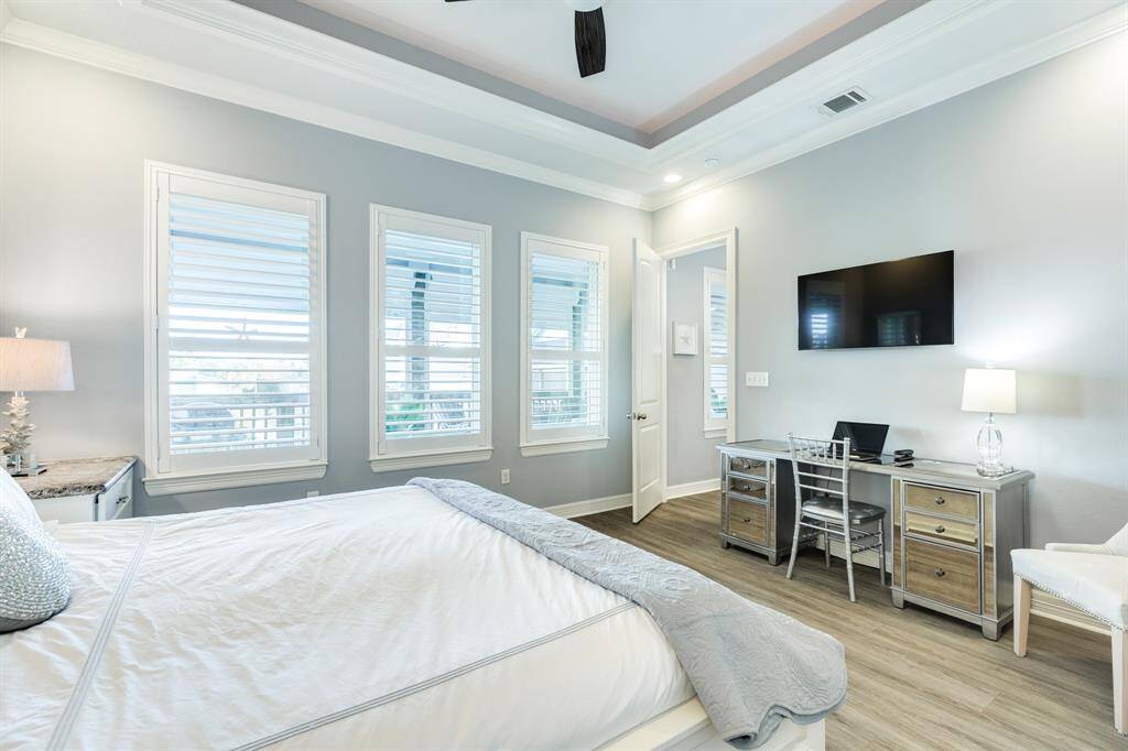 Primary bedroom. Abundant natural light and view of the main deck area. As you can see, this room is spacious with an office work station.