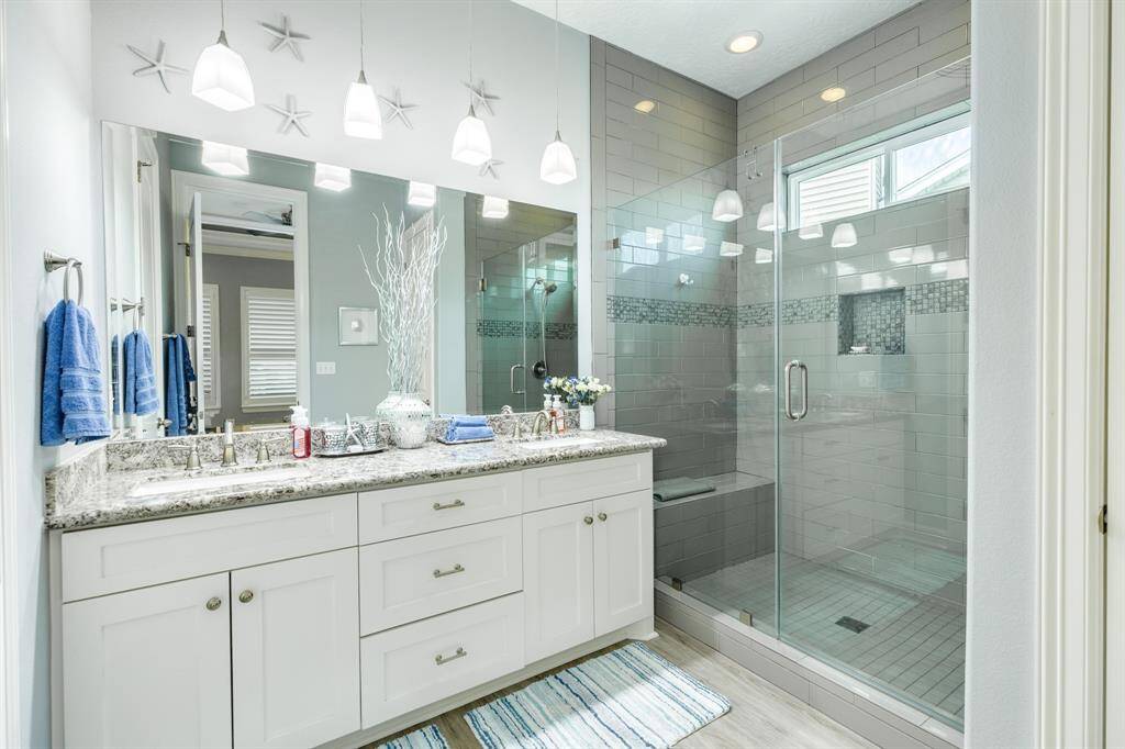 Primary bath view. Large walk-in shower, water closet, double vanity sinks, granite countertops & more!