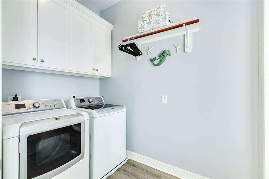 Nice large utility room (12 x 6) with upper cabinet storage.