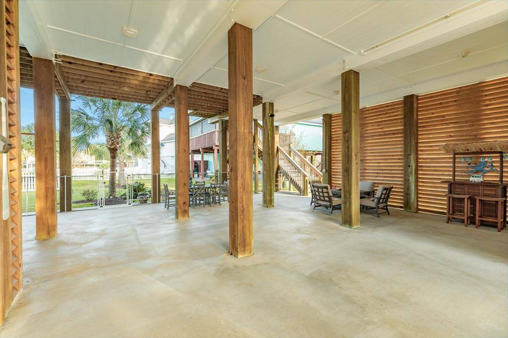 View through the patio area looking from the driveway towards the back of the home.