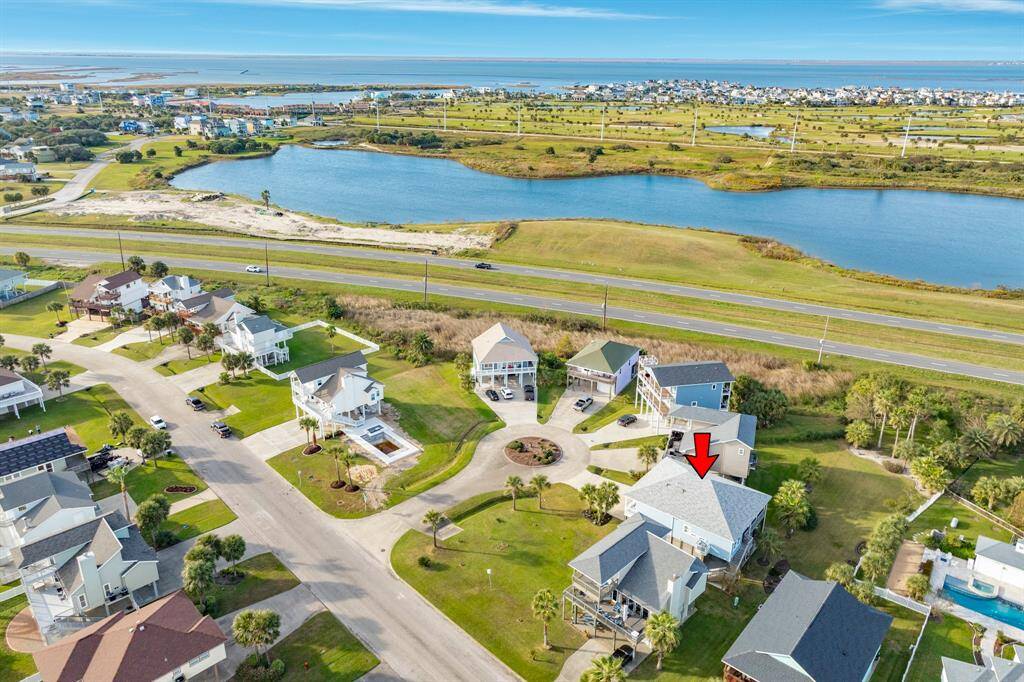 Aerial view showing home and the Galveston Country Club golf course and West Bay beyond. Easy golf cart ride to the GCC clubhouse, Watermans Restaurant & Marina.