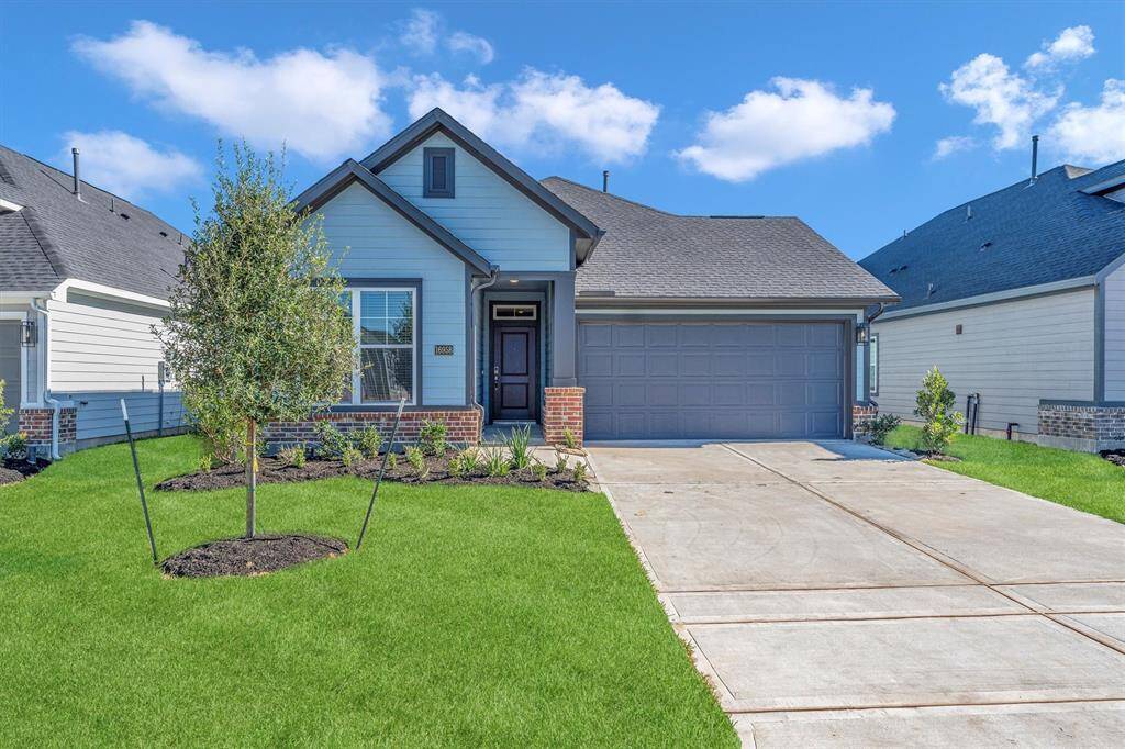 This charming single-story home features a modern exterior with a gabled roof and brick accents.